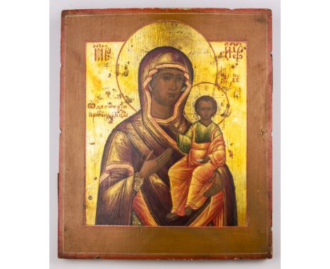 A 19th century icon depicting the Hodigitria Mother of God the figure in a red robe with the Christ child held in one arm, on
