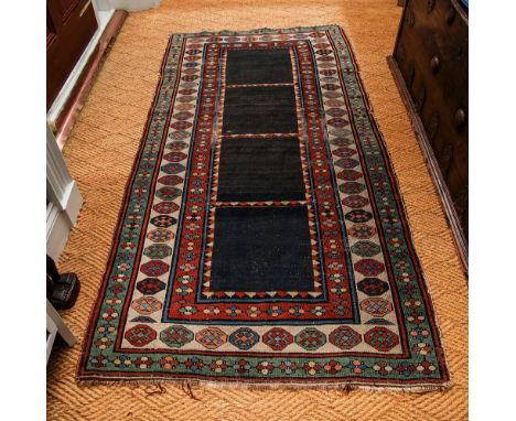 A Turkish rug early 20th century, the central field with toothed ladder design on a black ground, within multiple octagonal m