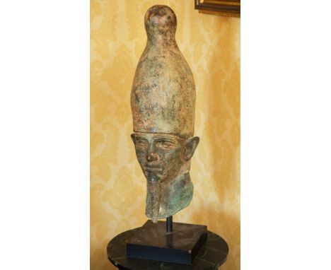 An Egyptian style bronze bust of a Pharaoh with verdigris patination, 25in. (63.5cm.) high including stand.