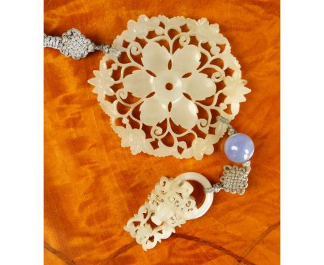 An antique Chinese jade yu-hua rosette in transparent very pale green jade, the six petalled flower surrounded by an openwork