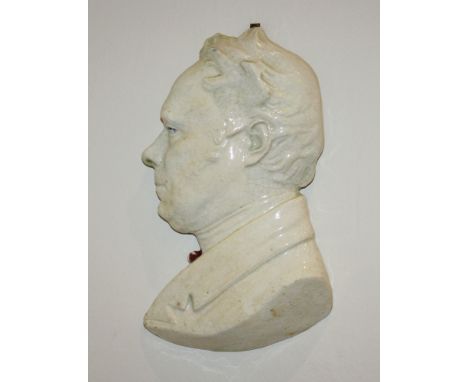 A 19th century white glazed china portrait plaque of a gentleman signed indistinctly and dated 1885, 9in. (22.75cm.) high.