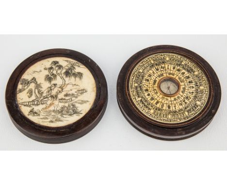 An Oriental carved bone and hardwood zodiac compass the cover and base with inset engraved bone plaques depicting a fisherman