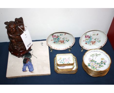 A set of Oriental enamel dishes, carved hardwood figure, pair of famille rose saucers &amp; Oriental tile.
