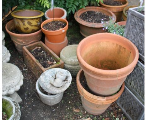A large tapered terracotta pot together with an oblong terracotta planter; three other terracotta planters; a Chinese brown g