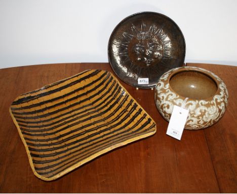 A crackle glazed stoneware bowl 9in. (23cm.) diameter, together with a large comb decorated studio pottery dish and a brown g