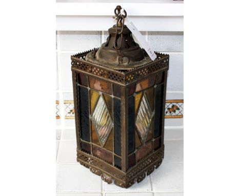 An Edwardian stained glass and pierced metal hall lantern