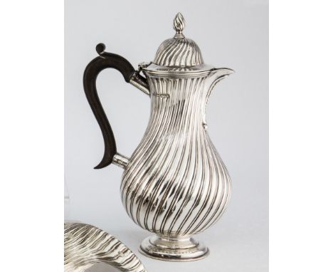 A Victorian silver baluster coffee pot Edward Hutton, London 1882, with all over spiral reeded decoration and conforming dome