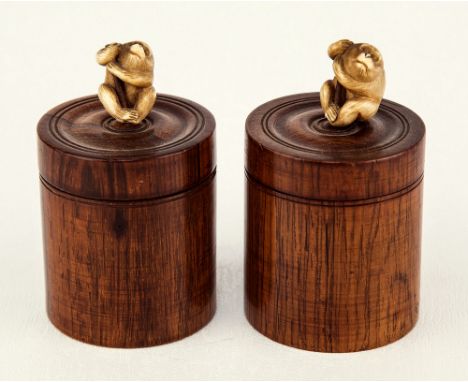 A pair of Japanese turned rosewood counter boxes Meiji period, cylindrical form, each with a carved ivory macaque finial, wit