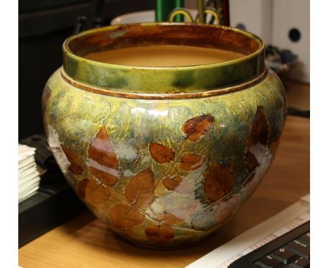A Royal Doulton stoneware jardinière decorated with ash leaves on a blue and light brown mottled and textured ground, impress