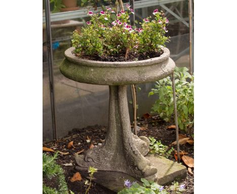 A shallow bowl planter on triple dolphin base in reconstituted stone, 22in. (56cm.) diameter at rim, 24½in. (62.2cm.) high.