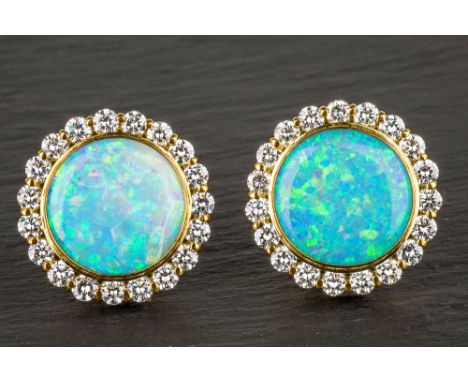 A fine pair of 18ct gold, opal and diamond cluster earrings by N. St. J. Paint of Guernsey, the 15mm. circular opals within a