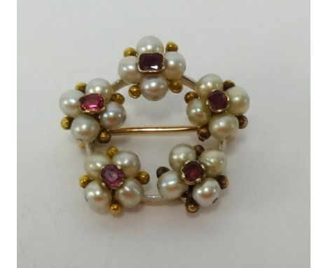 A pearl and ruby flower brooch, set in yellow metal, diameter approx 25mm.
