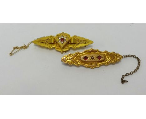 A Victorian 9ct plaque brooch set with ruby and diamonds, approx 3.8gms and another similar brooch 2.6gms (2).