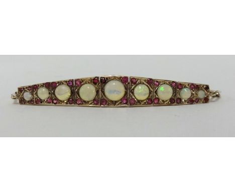 A nine stone opal and ruby set bracelet.