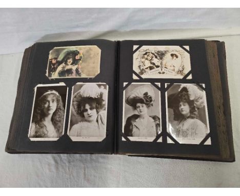 AN OLD ALBUM OF VINTAGE POSTCARDS