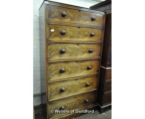 A Victorian walnut chest of six long drawers, 169 x 91.5cm, part of a larger item of furniture.