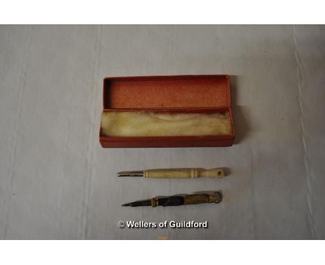 An small bone propelling pencil carved as a fist, lacks stanhope; a further small propelling pencil made covered in animal ha