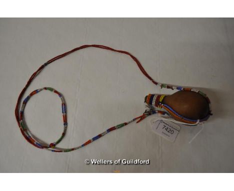 An African gourd flask with beadwork chain