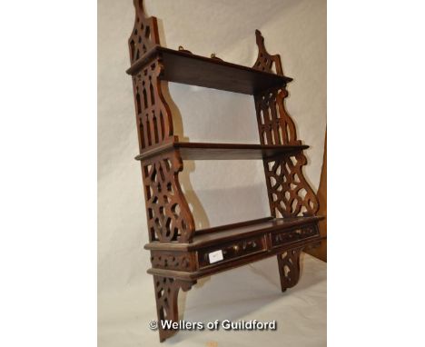 A mahogany wall shelf with two small drawers.