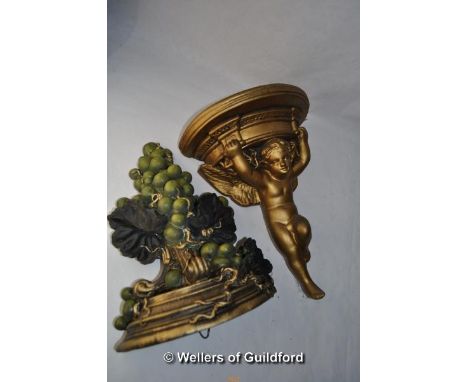 A gilt wall bracket moulded with a cherub; another wall bracket moulded as large bunch of grapes.