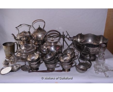 A quantity of silver plated wares including spirit kettles with stands, a punchbowl with cups, a circular tray, etc.