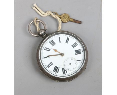 A silver cased pocket watch with key. Having enamel dial and subsidiary seconds (AF).