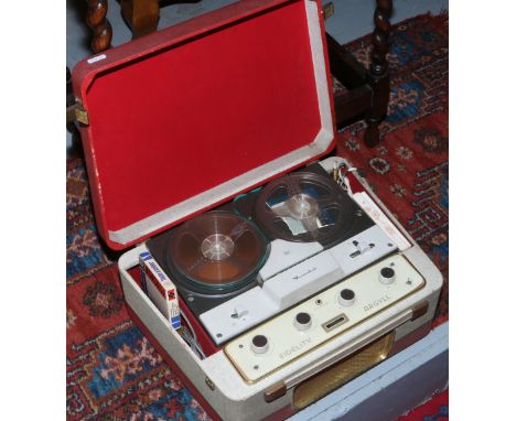 A vintage BSR Manandeck reel to reel tape recorder in red and cream vinyl case. 
