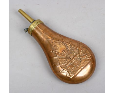 A copper and brass powder flask with embossed military detail.