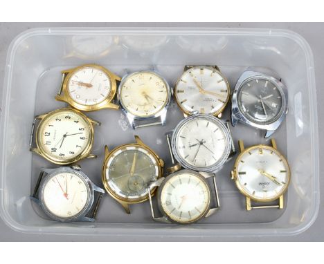 A box of gents vintage manual watch heads including Timex.