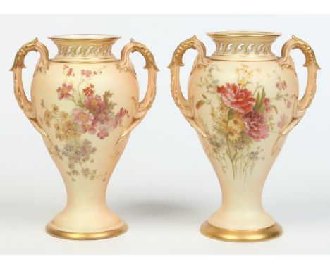A matched pair of Royal Worcester blush ground potpourri vases of baluster form and with twin scrolling handles. Heightened i
