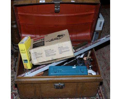 A tin travelling trunk and contents of hand and power tools to include Bosch power driver, Makita angle grinder and battery d