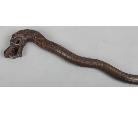 An oriental carved wooden walking stick formed as a serpent.