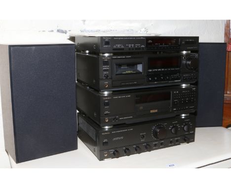 Four Technics hi fi seperates, integrated amplifier, compact disc, tuner and cassette deck with a pair of 40 watt speakers.