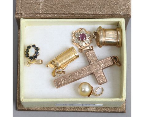 A box of 9ct gold pendant and charms including ruby, opal and a cross pendant.