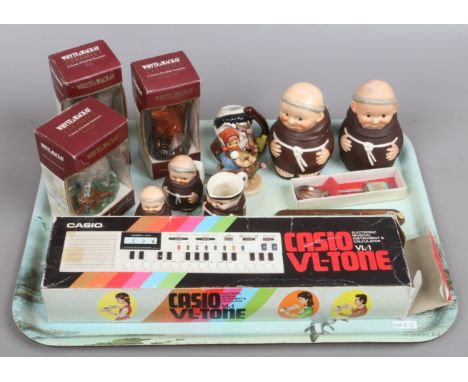 A tray of collectables to include Goebel ceramic figures, Whyte & Mackay ceramic Scotch Whisky souvenirs and a Casio VL-Tone 
