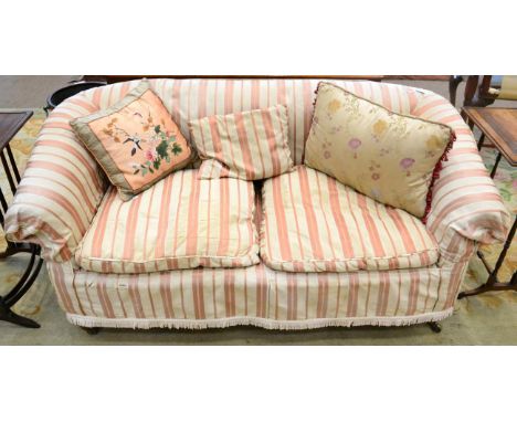 ^ A Victorian two seater sofa, mid-19th century, with rounded arm supports and squab cushions with striped loose cover raised