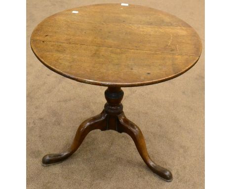 A George III oak flip top tripod table, late 18th century, with circular top above varsey formed stem and three cabriole legs