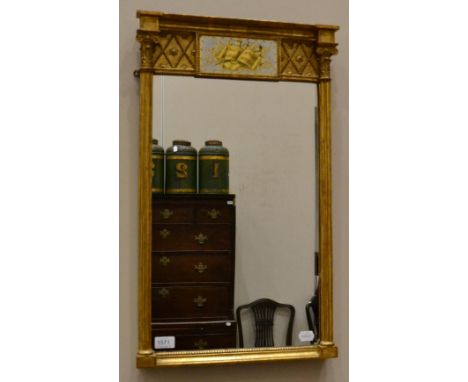 A Regency gilt and gesso pier glass, early 19th century, with a burr eglomise panel, decorated with a song book and musical t