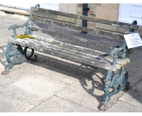 A Victorian wooden slatted cast iron garden bench with dog form arms, 151cm wide 