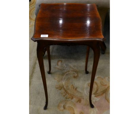 A late 19th century rosewood occasional/lamp table of serpentine shaped form, raised on slender cabriole legs, with acanthus 