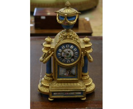 A French gilt metal mantel clock, late 19th century of architectural form set with sevres style porcelain panels, 39cm high 