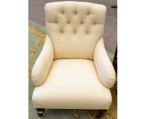 A Victorian nursing chair, circa 1860, recovered in cream button back floral fabric, raised on turned forelegs, with castors,