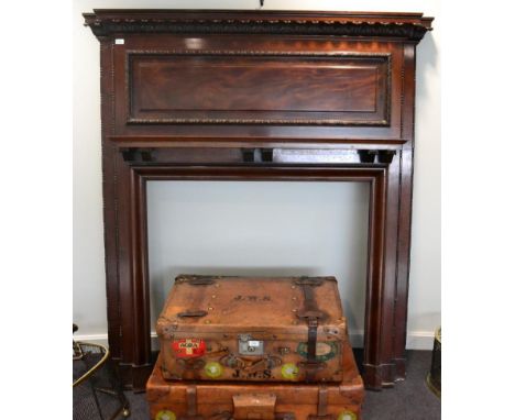 An Edwardian carved mahogany fire surround, of breakfront form with an acanthus carved frieze above a moulded panel and mante