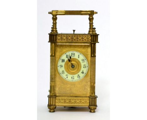 A brass striking and repeating carriage clock, circa 1900, carrying handle and repeat button, enamel dial with Arabic numeral