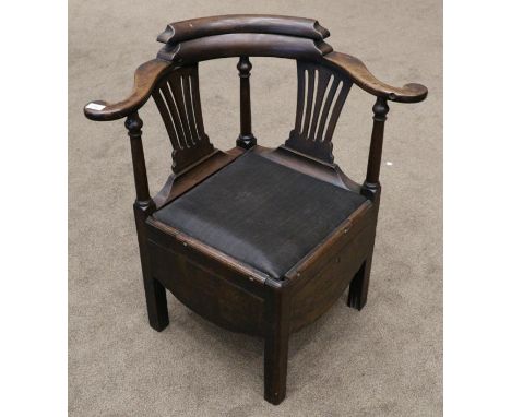 An 18th century mahogany commode elbow chair, diameter 79cm 