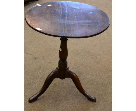 < An 18th century oak bird cage tripod table, with circular top, raised on a turned varsey form support, 62cm diameter 