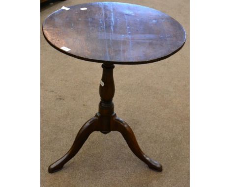 < An 18th century oak bird cage tripod table, with circular top, raised on a turned varsey form support, 62cm diameter 