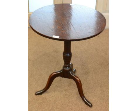 A George III oak tripod table, late 18th century with circular flip top raised on a varsey form support and three cabriole le