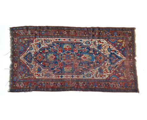 19th century Khamseh rug, South West Iran, the ivory field centred by an indigo floral panel framed by madder borders of styl