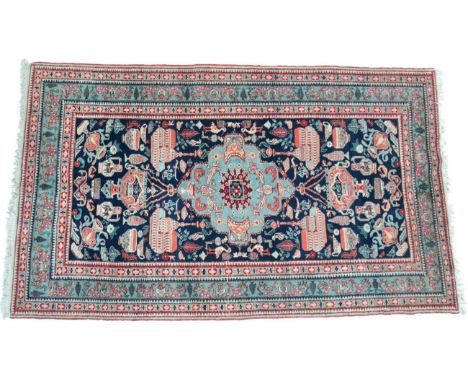 Azeri rug, North West Iran, the deep indigo field centred by a turquoise medallion enclosed by similar borders, 230cm by 143c